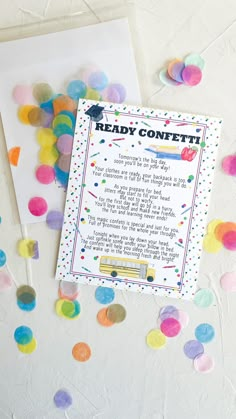 the ready confetti card is next to some confetti on a table