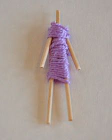 two wooden sticks with purple yarn on them