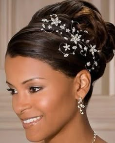 a woman in a wedding dress wearing a bridal hair piece with flowers on it