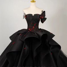 Elevate your wedding day with a touch of dramatic elegance in our Plus Size Gothic Ball Gown, a stunning tribute to gothic romance and sophisticated design. This gown is a symphony in black, crafted with luxurious fabrics that cascade into a full ballroom skirt, making every step you take a statement of grandeur. The off-shoulder neckline is adorned with exquisite black and red flowers, bringing a bold and beautiful contrast that captures the eye and ignites the imagination. These floral accents Black Wedding Dresses Plus Size, Black Dress With Roses, Gothic Ball Gown, Victorian Style Wedding Dress, Antique Wedding Dresses, Victorian Style Wedding, Wedding Dress Ball Gown, Nontraditional Wedding Dress, Skirt Making