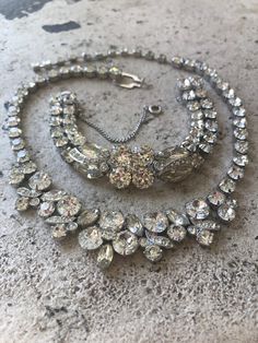 "Eisenberg Ice Necklace Bracelet Set - Vintage Designer Jewelry - Clear Crystal Brides Necklace - Wedding Jewelry - Two Piece Jewelry Set How stunning is this Eisenberg Ice Necklace/Bracelet Set? Perfect statement piece for your wedding or any special occasion. The necklace is approximately 16 1/2\" long and features a single strand of prong set Dentelle Rhinestones which doubles in the front. It is accented with Pave Ribbon Accents. The bracelet is 6\" long with the same features as the necklac Eisenberg Ice Jewelry, Brides Necklace, Ice Jewelry, Ice Necklace, Designer Costume Jewelry, Bride Necklace, Vintage Designer Jewelry, Geometric Fabric, Set Jewelry