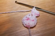 a crocheted object is being worked on with a knitting needle