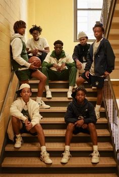 a group of young men sitting on top of stairs