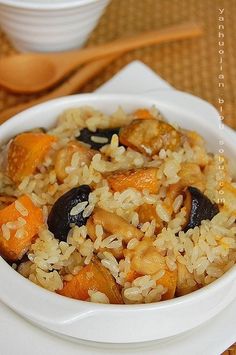 a white bowl filled with rice and vegetables