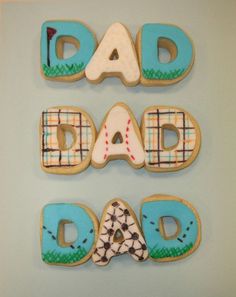 decorated cookies with the words dad, dad and baby written in icing on them