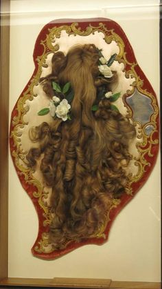 an image of a woman's hair with flowers on it in a glass frame