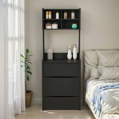 a bed room with a neatly made bed and a shelf