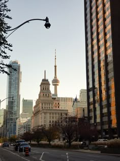 a city street with tall buildings in the background