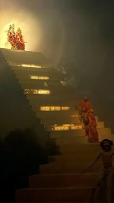 a person walking up some stairs in front of a light that is shining on them