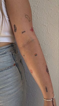 a woman's arm with tattoos on it