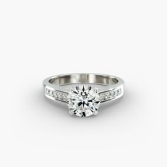 a white gold engagement ring with channel set diamonds