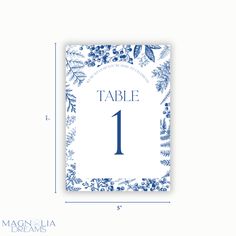 a table number card with blue flowers and leaves