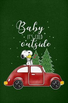 a red car with a snoopy dog sitting on the hood and saying baby it's cold outside