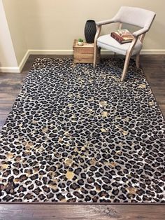 a leopard print area rug with a chair in the corner and a vase on the floor