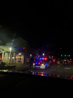 the police car is parked on the side of the road in front of the fire station