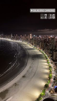 an aerial view of a beach and city at night