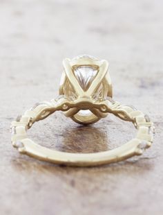 a yellow gold ring with a diamond in the center