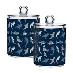 two blue canisters with sharks on them, one has a glass lid and the other has a metal handle