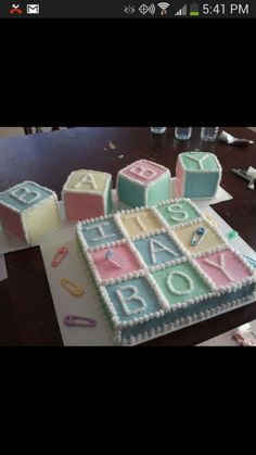 a cake that is sitting on top of a table in the shape of blocks and letters