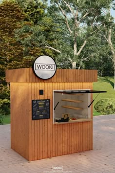 a small wooden kiosk with a sign above it