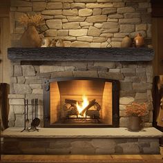 a stone fireplace with a fire in it