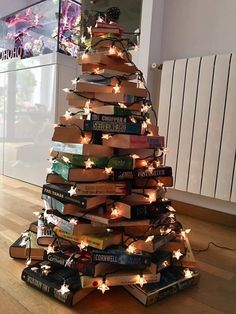 a christmas tree made out of books with lights