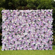 a large purple and white flowered wall in the grass