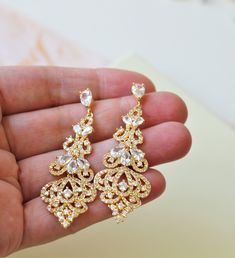 Gold Bridal Earring Crystal Earring Vintage Style Wedding Earring Chandelier  Wedding Jewelry Bridesmaid Earrings   Vintage style zircon  earrings  Colour: yellow gold /clear Measurements: approx 5.8 cm including studs(medium size not very long).  Materials:  rhodium components, zircon crystals . Stud earrings. Great for wedding or other celebration. Same style in rose gold: MORE SAME STYLE: https://www.etsy.com/uk/shop/BridalArtDeco?ref=listing-shop-header-item-count&section_id=23918122 Please Elegant Drop Diamond Earrings For Wedding, Glamorous Hand-set Wedding Earrings, Glamorous Wedding Earrings With Elegant Design, Glamorous Drop Diamond Earrings For Wedding, Glamorous Hand Set Earrings For Wedding, Glamorous Wedding Diamond Earrings With Elegant Design, Glamorous Diamond Earrings With Elegant Design For Wedding, Elegant Wedding Diamond Earrings, Gold Cubic Zirconia Chandelier Earrings With Elegant Design