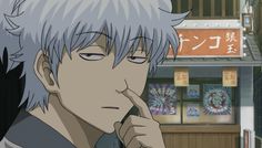 an anime character with white hair and blue eyes looking at something in front of him