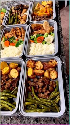 several trays filled with different types of food