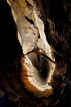 a man standing in the middle of a cave