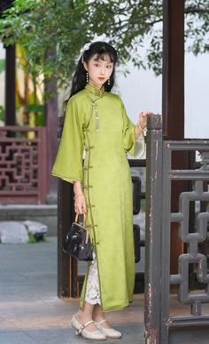 A satin qipao reminiscent of a fresh bamboo grove, the Liu Huang 柳黄 1930s Qipao is comfortable and soft for daily wear. Featuring 1930s style three-quarter bell sleeves, triple knot collar, and lower side slits, this dress can be styled up or down for any occasion. Vintage cut qipaos are designed to be looser around the waist, allowing them to be more comfortable than modern day cheongsams. It is recommended to add 2-3cm to your measurements to ensure you get the correct vintage fit. This item h Qipao Outfit, Qipao Vintage, Cheongsam Vintage, Bamboo Grove, Cheongsam Modern, Modern Qipao, 1930s Style, Hanfu Dress, Qipao Dress