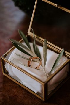 two wedding rings sitting in an open box