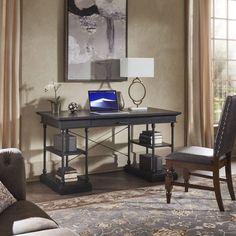 a laptop computer sitting on top of a wooden desk next to a chair and lamp