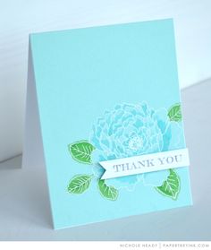 a thank you card with a blue flower and green leaves