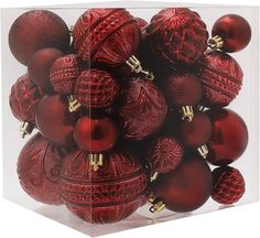 a clear box filled with red christmas ornaments