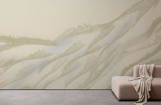 a couch and chair in front of a wall with mountains painted on the walls behind it