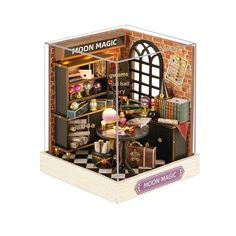 a wooden model of a room with furniture and accessories in it's display case