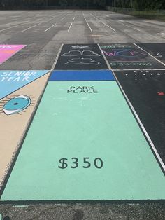 an empty parking lot with chalk drawings on it