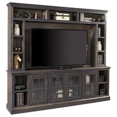 an entertainment center with bookshelves and a flat screen tv