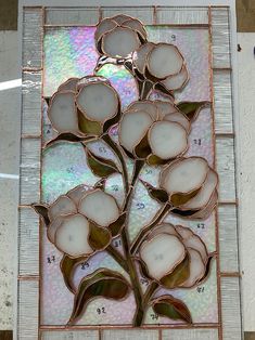 a stained glass window with flowers on it