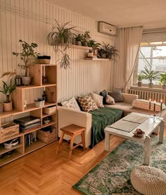 a living room filled with furniture and lots of plants