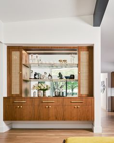 an empty room with wooden cabinets and shelves