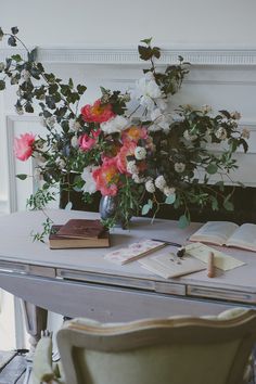 a table with flowers and books on it