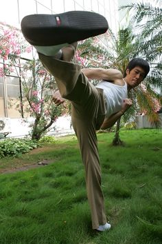 a man doing a handstand in the grass