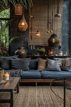 a living room filled with lots of furniture next to a wall covered in hanging lights