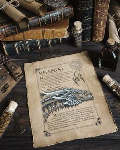 an old paper with a dragon on it next to some books and other antique items