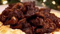 a close up of food on a plate with a christmas tree in the back ground