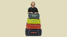 a man sitting on top of four luggage bags