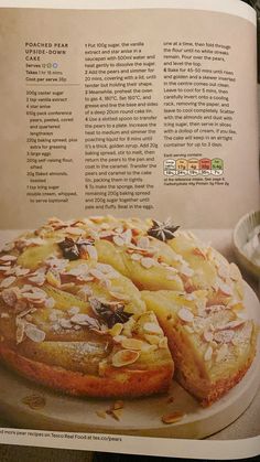 the recipe book is open to show an image of a cake with fruit on it